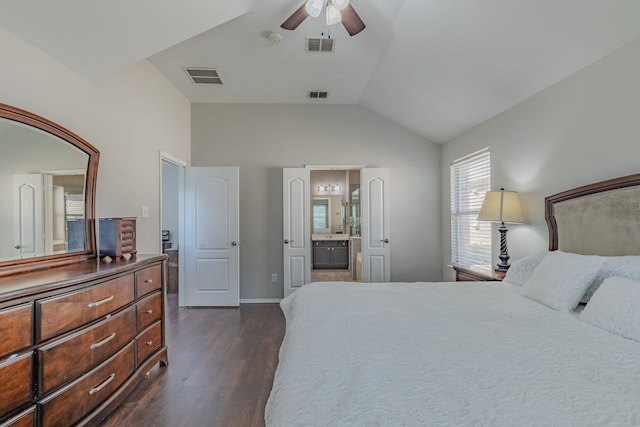 bedroom featuring dark wood-type flooring, ceiling fan, connected bathroom, and lofted ceiling