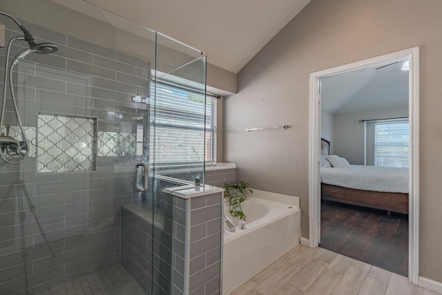 bathroom with independent shower and bath, hardwood / wood-style floors, and vaulted ceiling