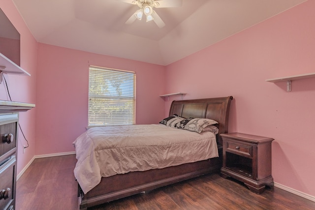 bedroom featuring dark hardwood / wood-style flooring, ceiling fan, and a tray ceiling