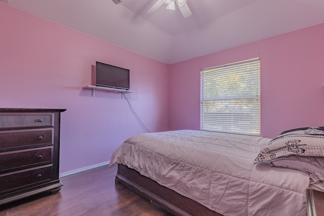 bedroom with dark hardwood / wood-style flooring and ceiling fan