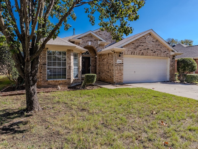 single story home featuring a garage and a front yard