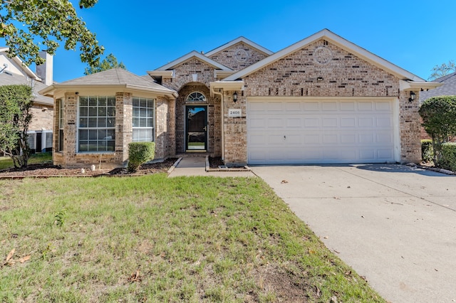 ranch-style house with a garage and a front yard