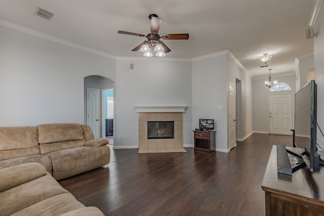 living room featuring ornamental molding, dark hardwood / wood-style floors, ceiling fan, and a tile fireplace