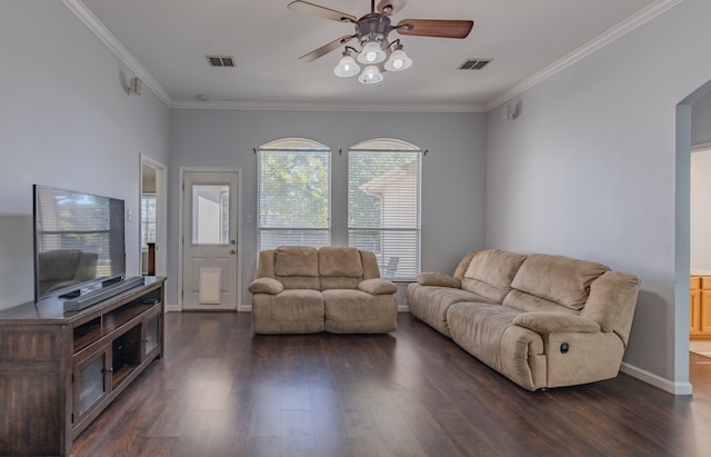 living room with dark wood-type flooring, ceiling fan, and crown molding