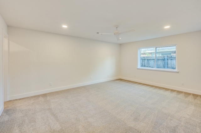 unfurnished room featuring light carpet and ceiling fan