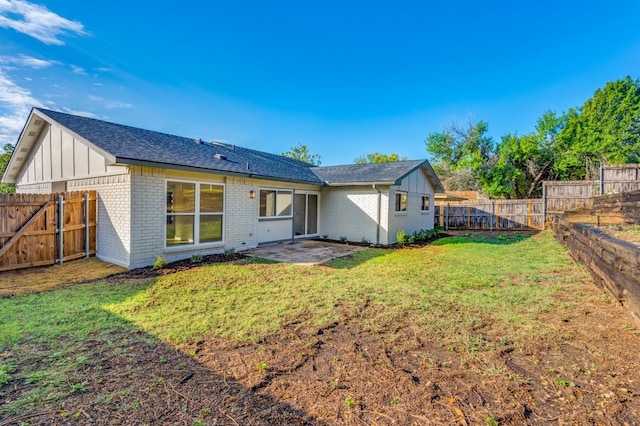 back of house featuring a patio and a yard