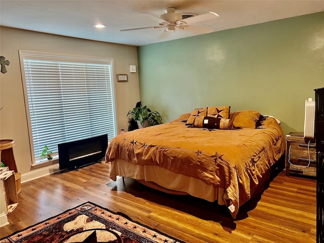 bedroom with hardwood / wood-style flooring and ceiling fan