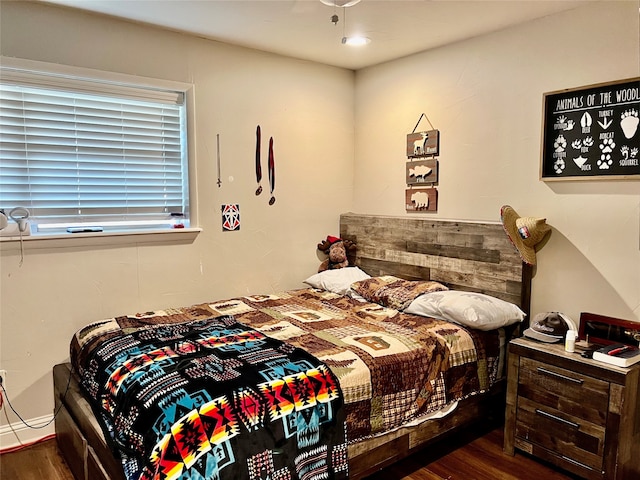 bedroom with dark wood-type flooring