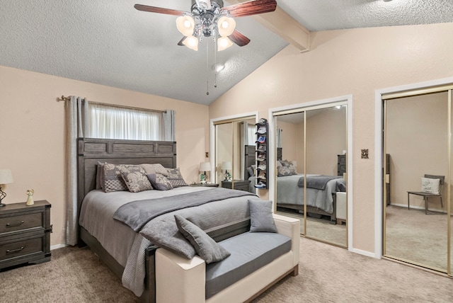 carpeted bedroom featuring multiple closets, ceiling fan, a textured ceiling, and vaulted ceiling with beams