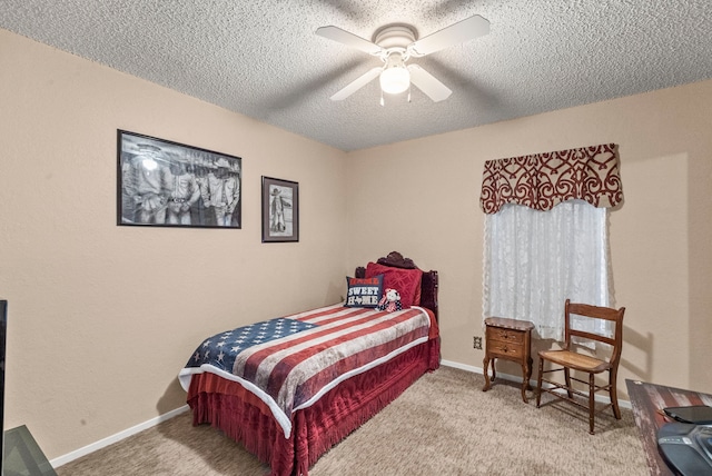 carpeted bedroom with a textured ceiling and ceiling fan