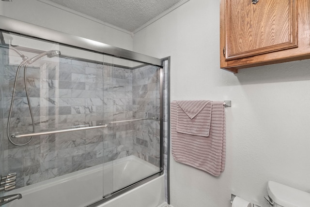 bathroom with toilet, crown molding, bath / shower combo with glass door, and a textured ceiling