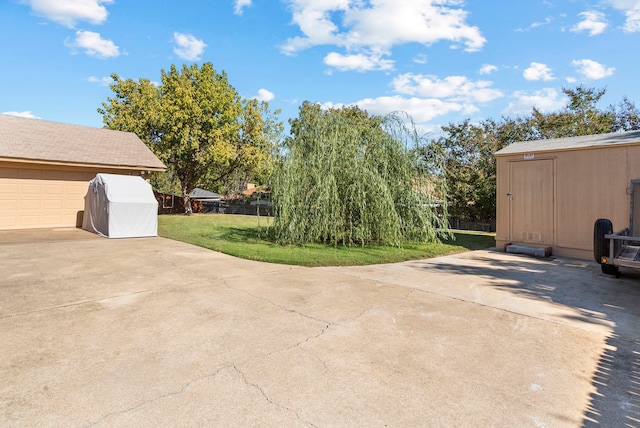 view of patio with a garage and a shed