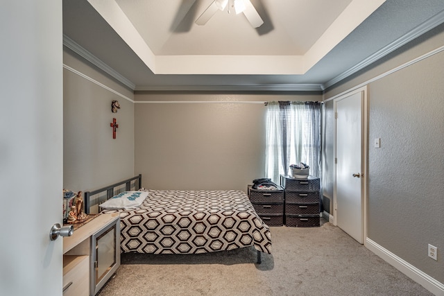 bedroom with ceiling fan, light carpet, a raised ceiling, and ornamental molding