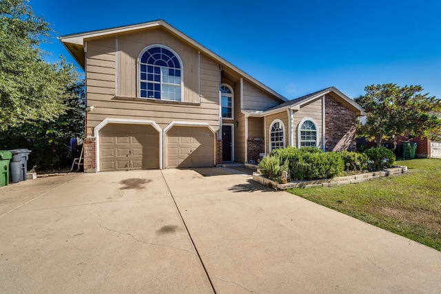 view of front property featuring a garage and a front yard