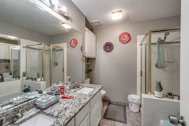 bathroom featuring vanity, toilet, and an enclosed shower