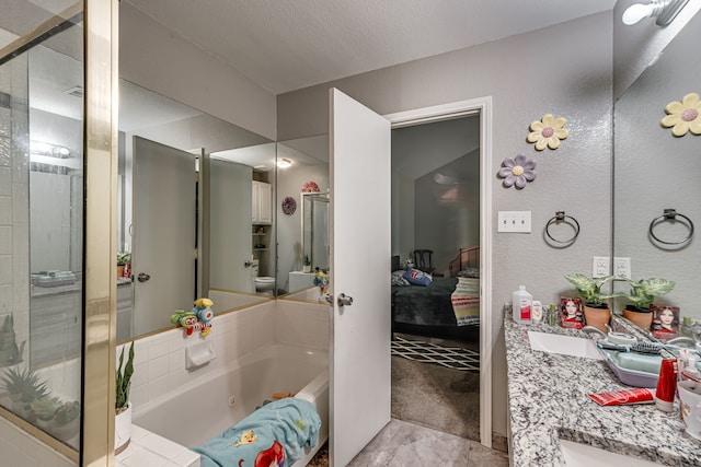 bathroom with vanity, shower with separate bathtub, and a textured ceiling