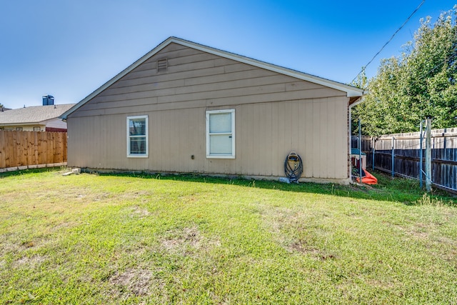 back of property featuring a lawn