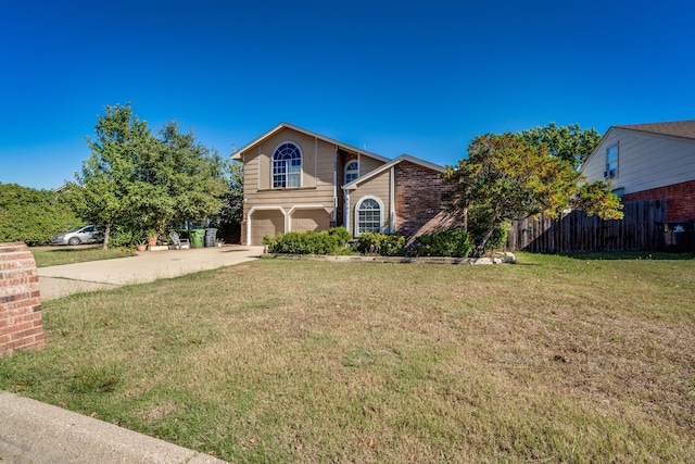 view of property featuring a garage and a front yard