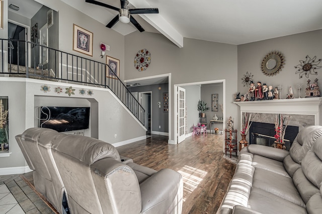 living room with a fireplace, hardwood / wood-style floors, beamed ceiling, and high vaulted ceiling