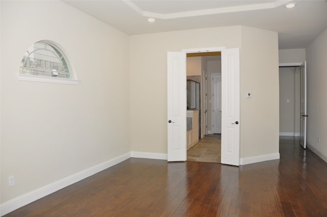 spare room with dark hardwood / wood-style floors