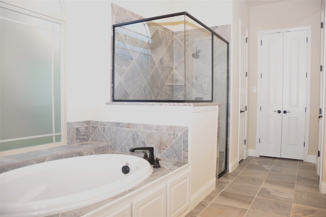 bathroom featuring separate shower and tub