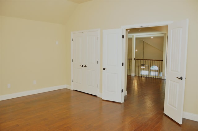 interior space featuring hardwood / wood-style floors and vaulted ceiling