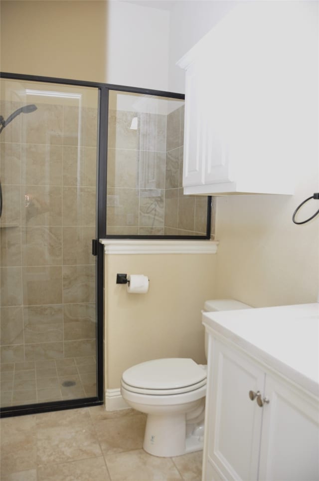 bathroom with walk in shower, tile patterned floors, vanity, and toilet