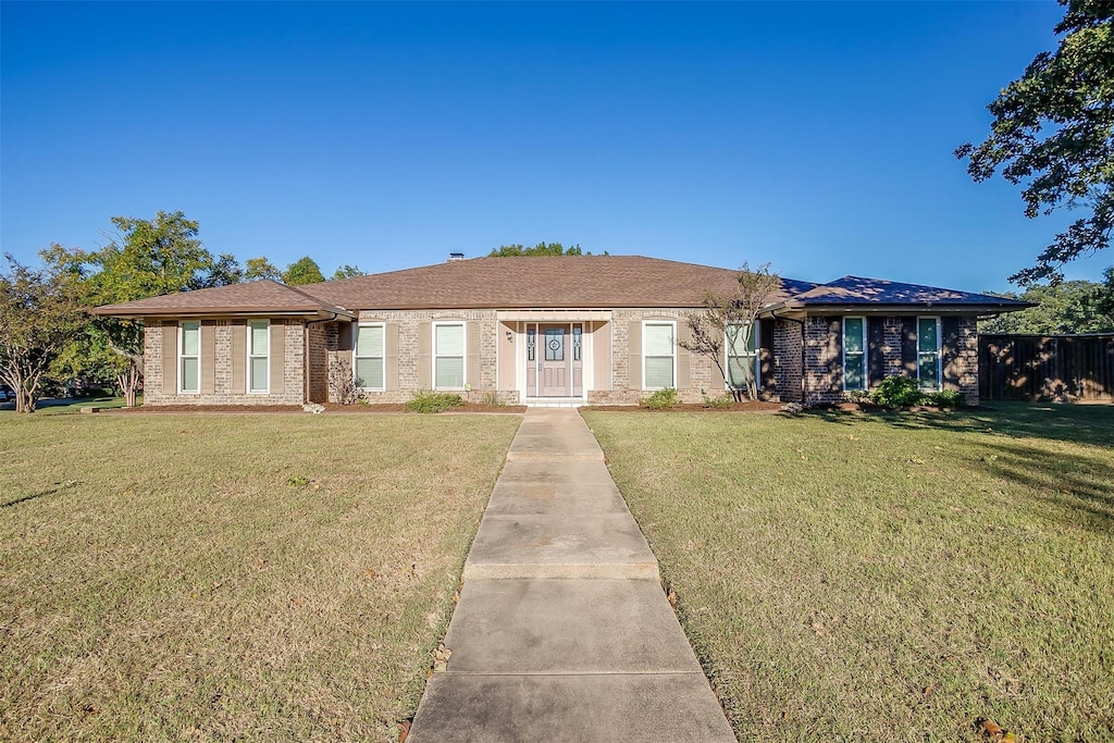 ranch-style home with a front lawn