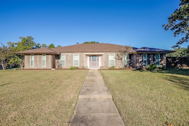 ranch-style home with a front lawn