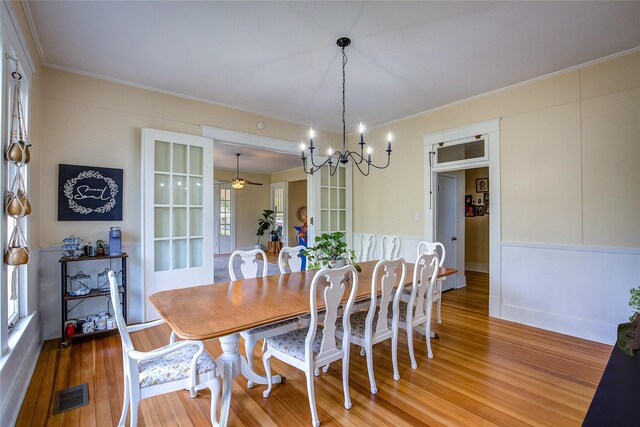 339 N 1st St, Point, TX 75472 - dining space featuring a chandelier, light wood-style flooring, crown molding, and a ceiling fan