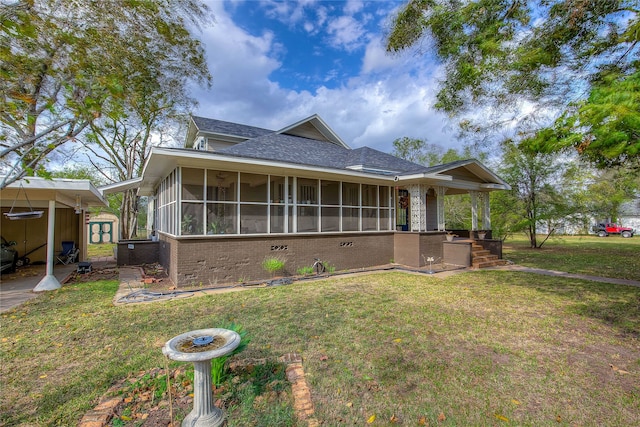 view of front of home with a front lawn and a sunroom