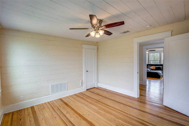 unfurnished room featuring ceiling fan, wood ceiling, and light hardwood / wood-style flooring