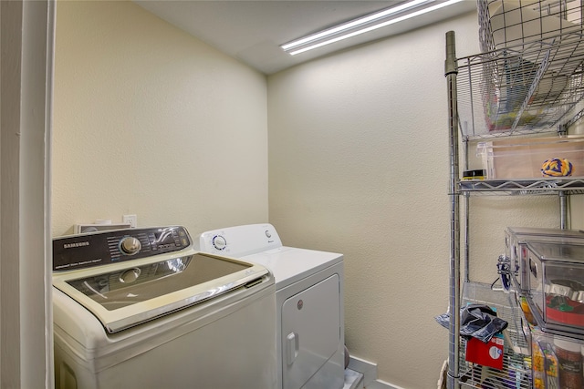 clothes washing area with independent washer and dryer