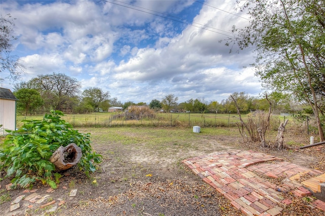 view of yard featuring a rural view and a patio