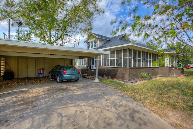 view of front facade with a front yard and a sunroom