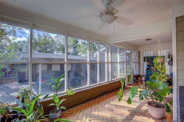 sunroom / solarium with a wealth of natural light and ceiling fan