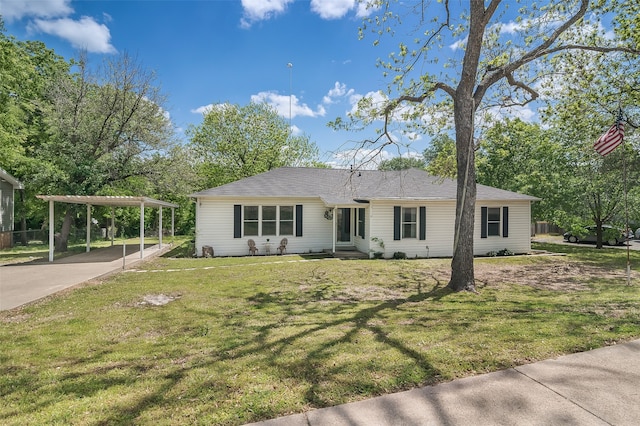 view of front facade featuring a front yard and a carport