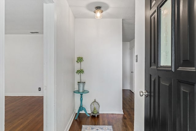 corridor with dark hardwood / wood-style floors