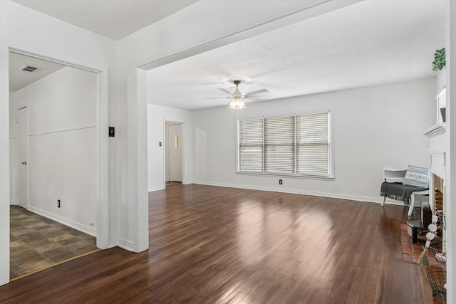 unfurnished living room featuring dark hardwood / wood-style floors, ceiling fan, and a fireplace