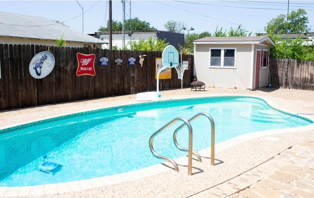 view of swimming pool with a patio and an outdoor fire pit