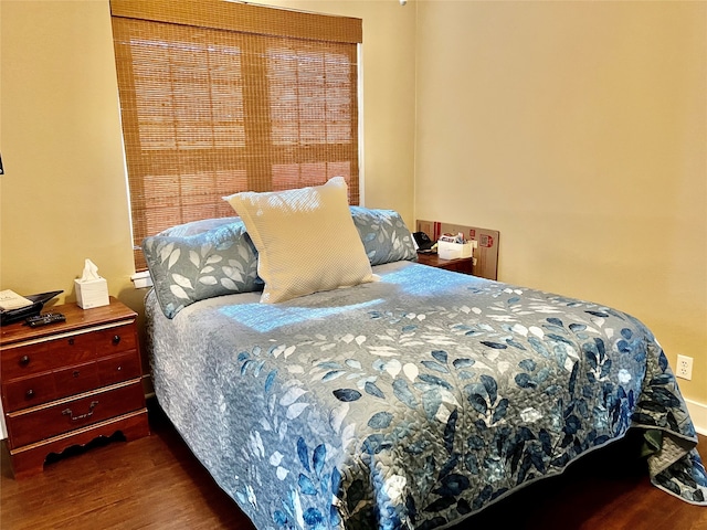 bedroom with ceiling fan and wood-type flooring