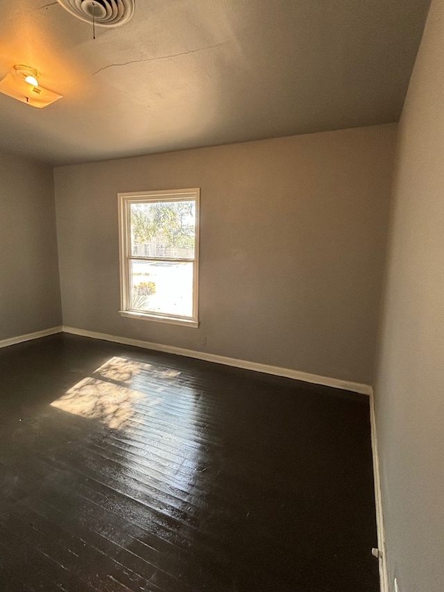 unfurnished room featuring dark wood-type flooring