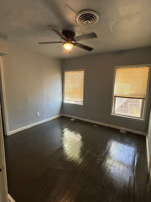 spare room featuring a textured ceiling, dark hardwood / wood-style flooring, and ceiling fan