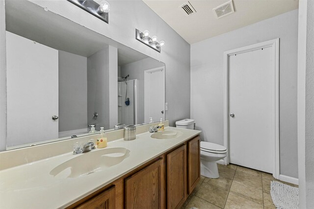 full bathroom featuring vanity, tile patterned flooring, toilet, and plus walk in shower