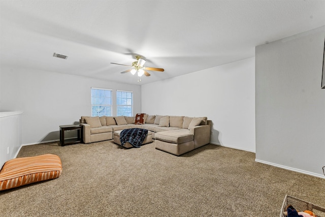 living room with ceiling fan and carpet