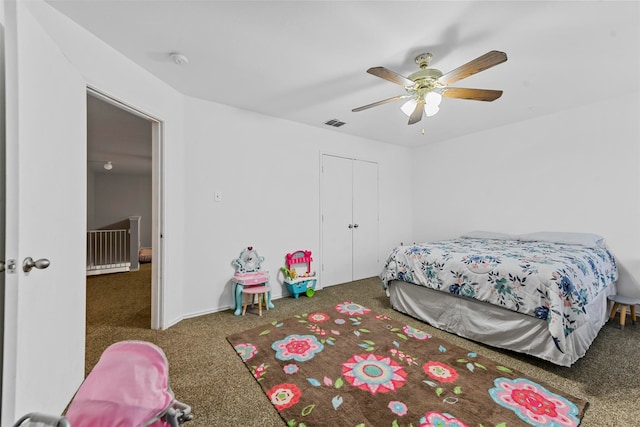 bedroom featuring ceiling fan, dark colored carpet, and a closet