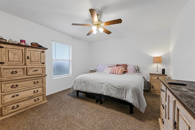 bedroom with ceiling fan and dark carpet