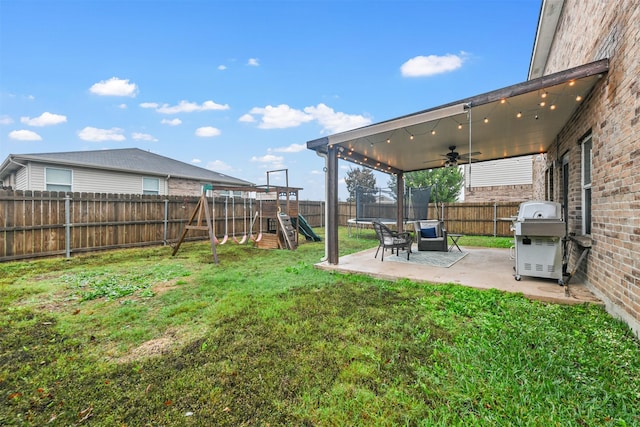 view of yard featuring a playground and a patio