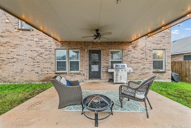 view of patio / terrace featuring ceiling fan, a grill, and an outdoor fire pit