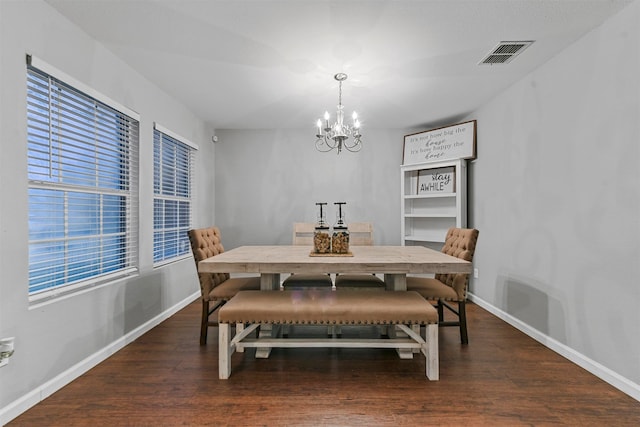 dining room featuring an inviting chandelier and dark hardwood / wood-style flooring